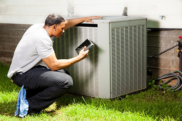Man Inspecting the Unit — Colorado Springs, CO — Home Heating Service, Inc.