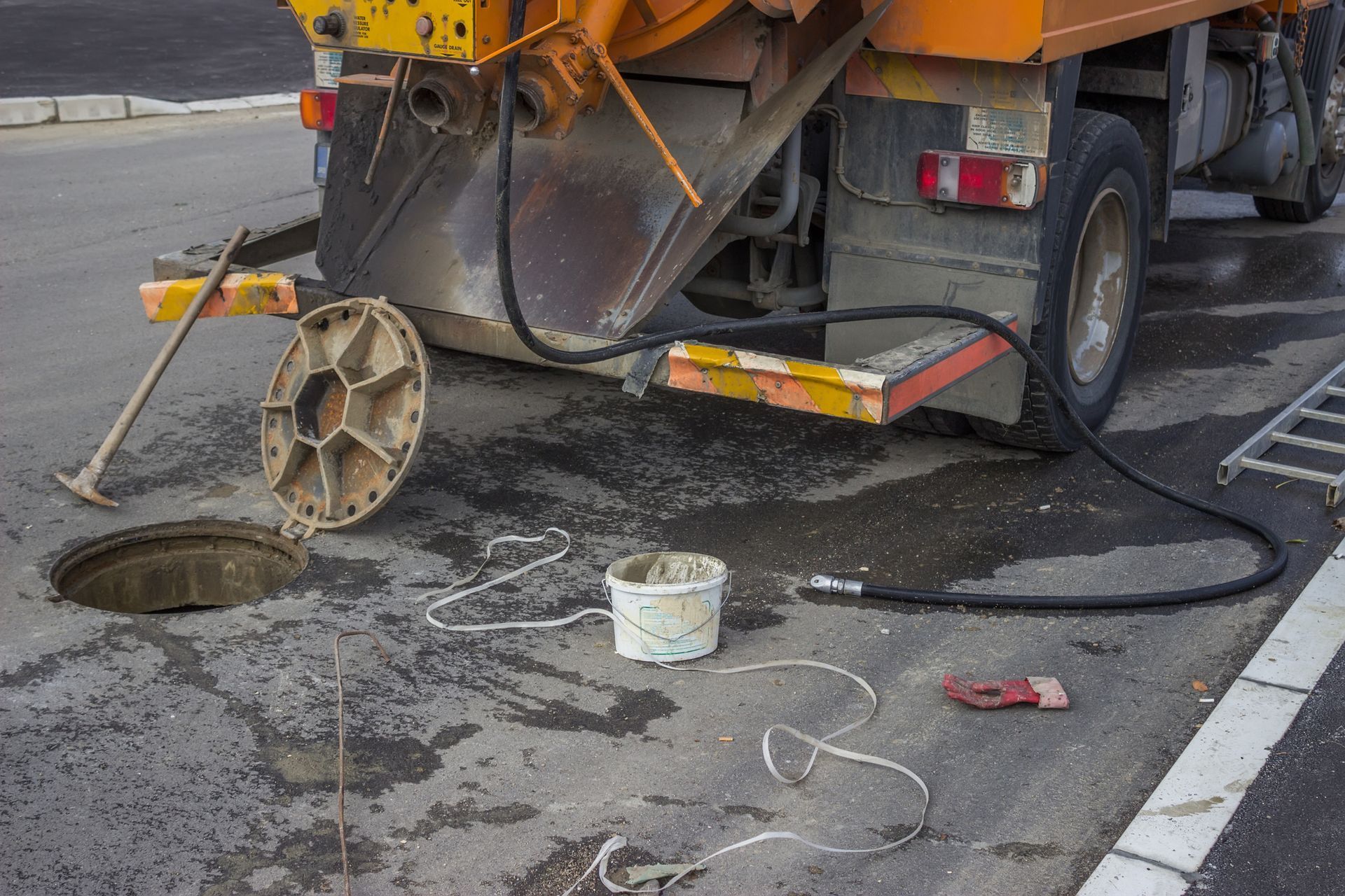 A truck doing a Sewer Cleaning with a bucket on the back