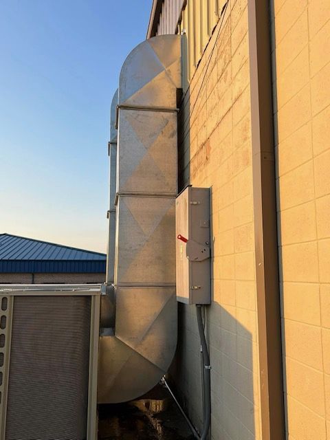a large metal pipe is attached to the side of a building