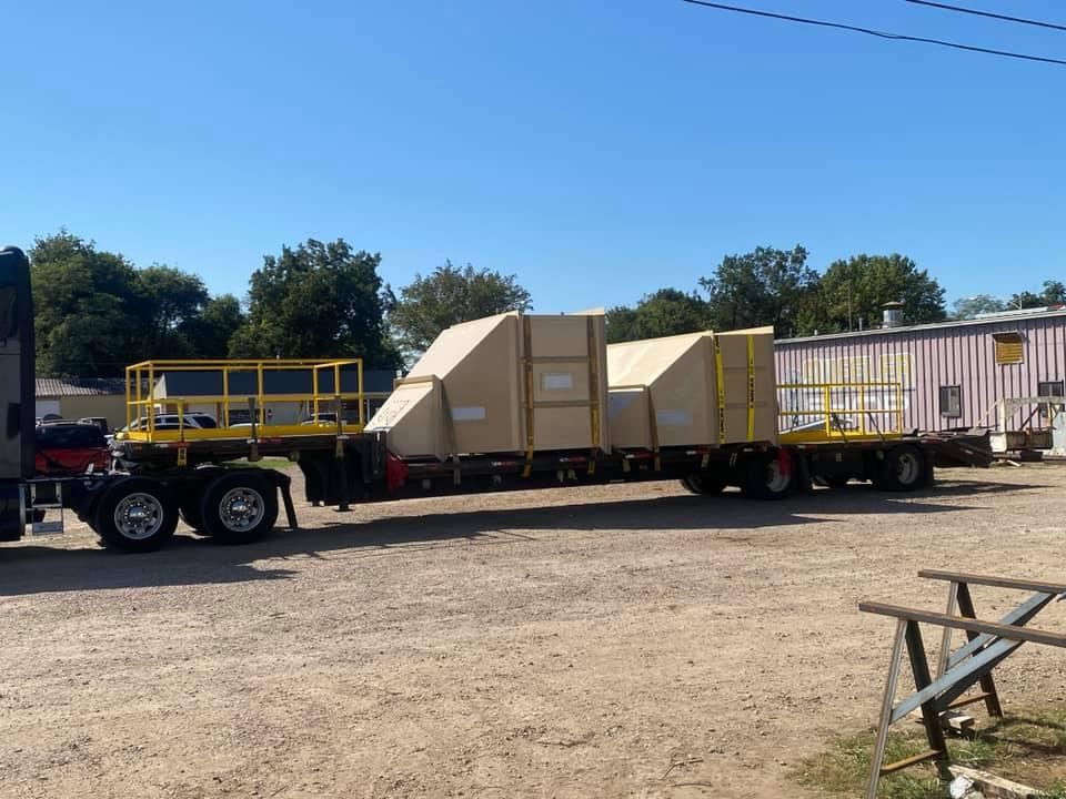 a truck is pulling a trailer with boxes on it