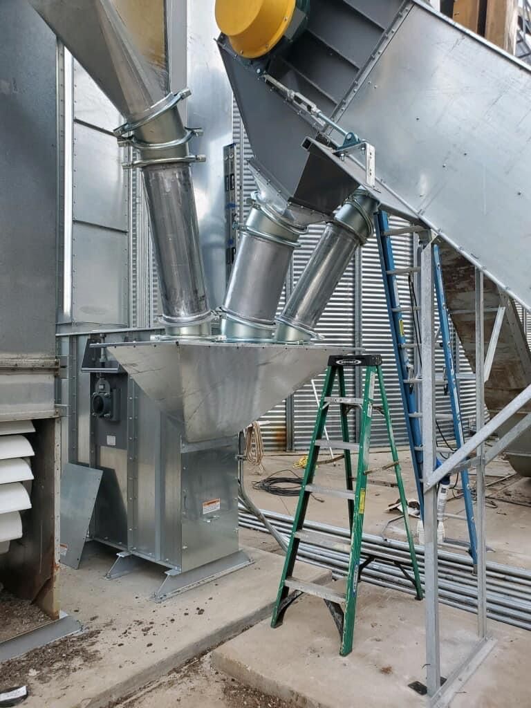 a ladder is leaning against a metal structure in a factory