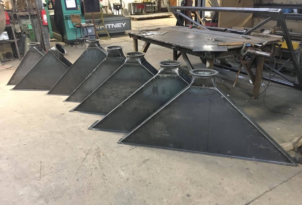a bunch of metal pieces are lined up on the floor