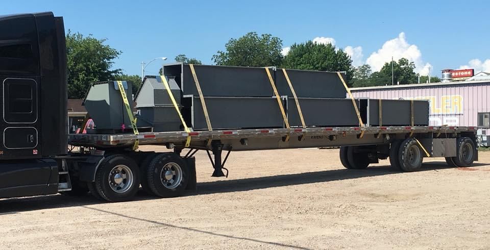 a semi truck is carrying a load of boxes on a flatbed trailer