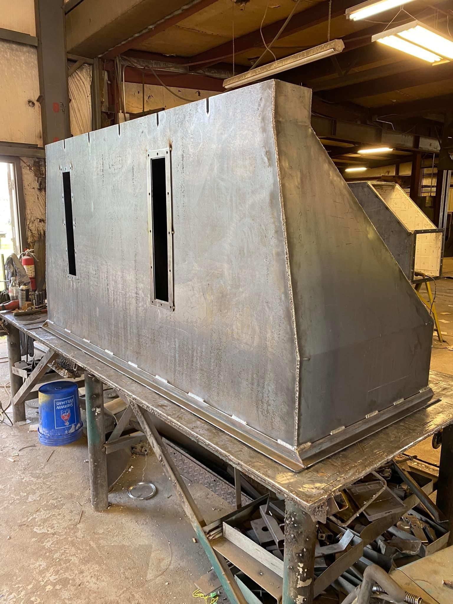 a large piece of metal is sitting on a table in a factory