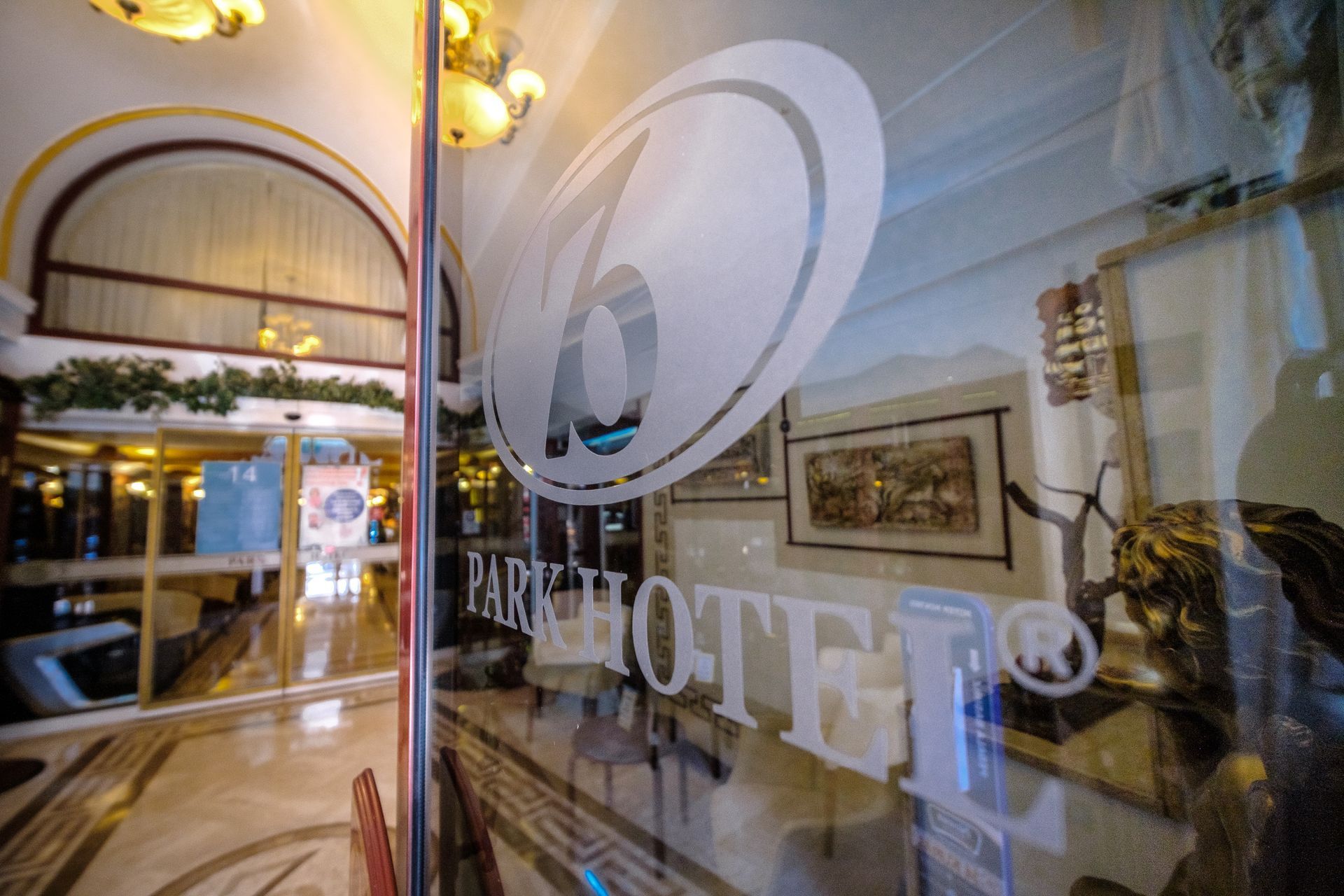 A glass door with the etched logo and name 
