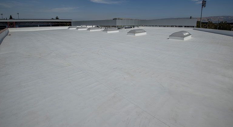 a white roof with a lot of skylights on it .