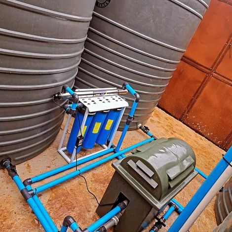 A machine is sitting in front of a bunch of water tanks