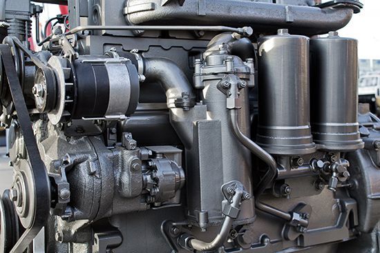 Close-up of a heavy-duty diesel engine with black cylindrical filters and metal components.
