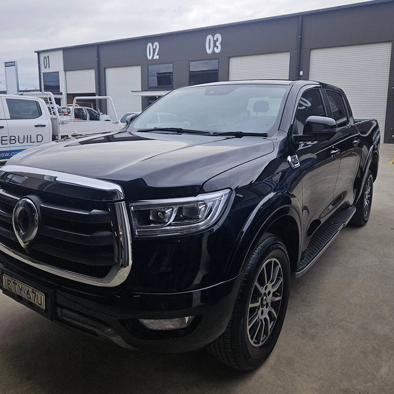 A Black truck is Parked in front of a Building with the Number 03 on it — On Point Detailing Wagga in East Wagga Wagga, NSW