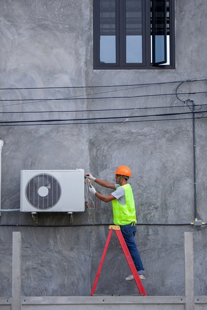 Construction Worker Installing an Air Conditioner Unit — Hinterland Air Conditioning Sunshine Coast in Kiels Mountain, QLD