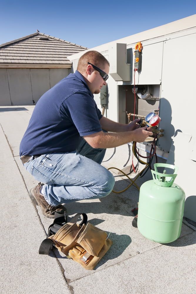 HVAC Technician is Checking Air Conditioning Unit — Hinterland Air Conditioning Sunshine Coast in Montville, QLD