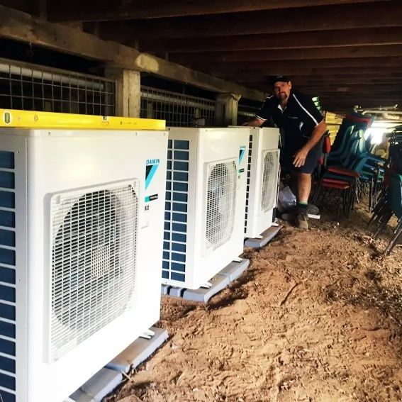 Man Installing Air Conditioning Units Under a Structure — Hinterland Air Conditioning Sunshine Coast in Palmwoods, QLD