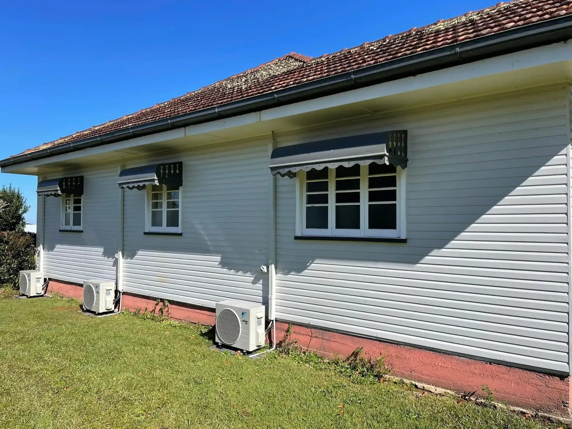 White House With Awnings and Air Conditioning Units — Hinterland Air Conditioning Sunshine Coast in Palmwoods, QLD