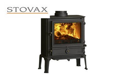 Black wood-burning stove with fire visible inside,