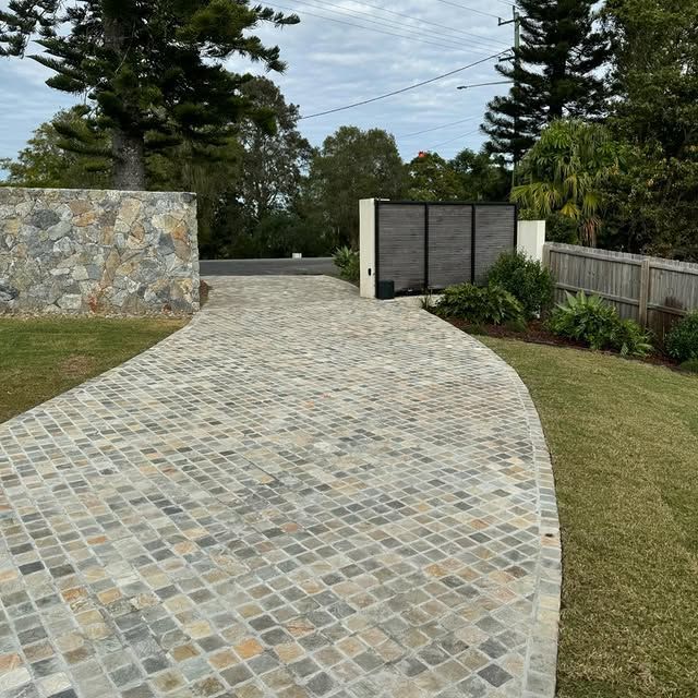 A Brick Driveway Leading to a House With Trees in the Background  — Bloomscapes in Lennox Head NSW