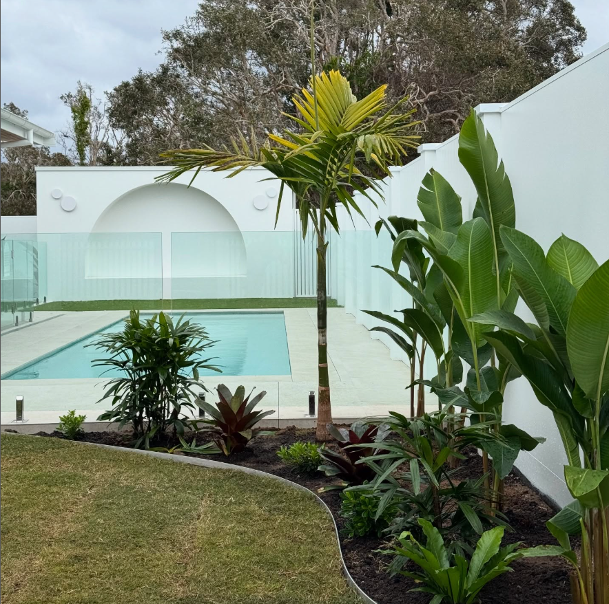 A Stone Walkway in a Park With Potted Plants on the Side — Bloomscapes in Lennox Head NSW