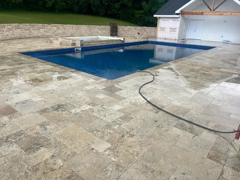 A large swimming pool is being built in a backyard