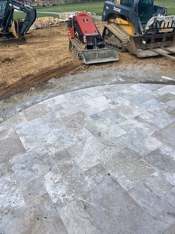 A bulldozer is sitting on top of a tiled floor in a construction site.