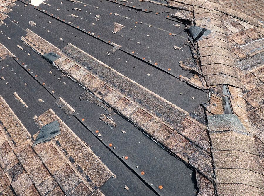 A close up of a roof with a lot of shingles missing