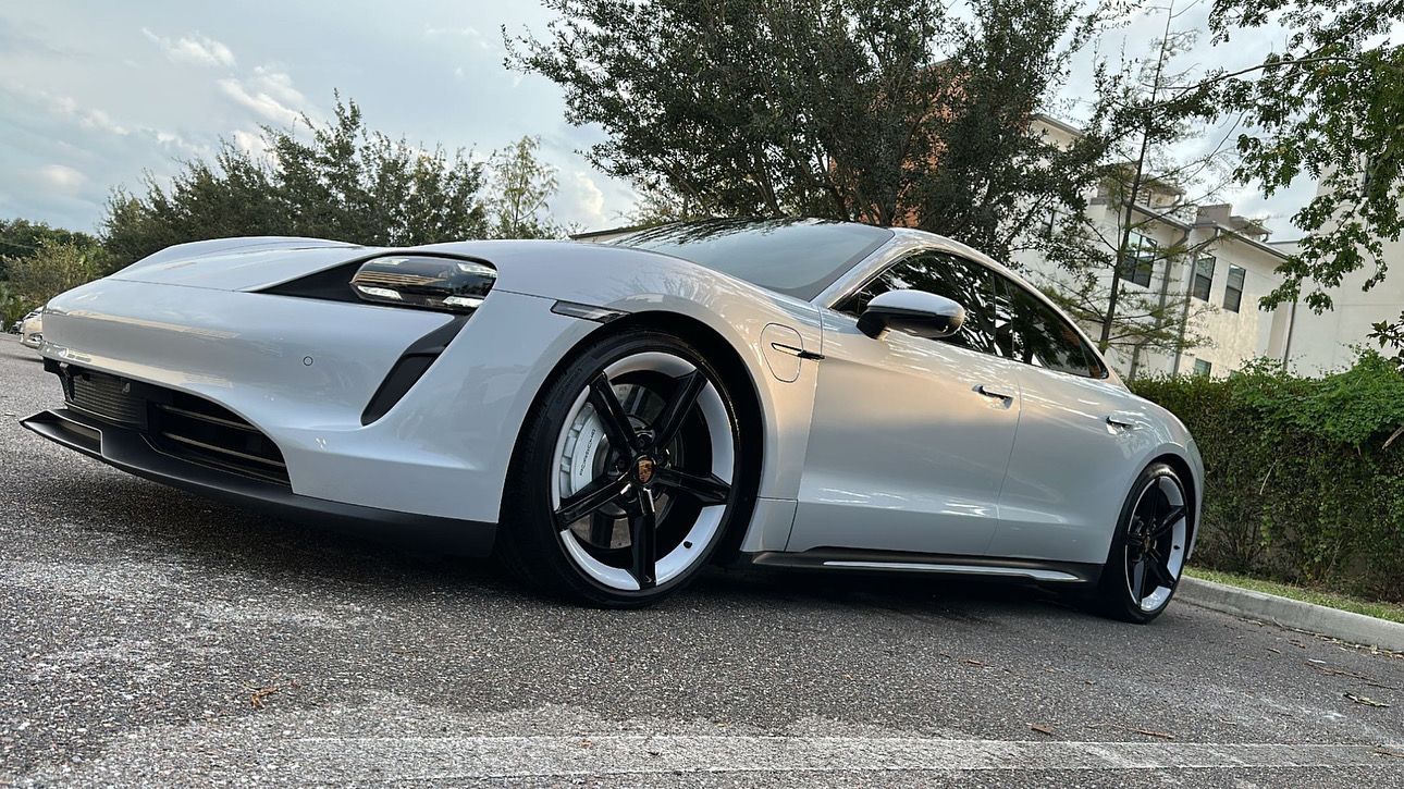 A silver sports car is parked on the side of the road.