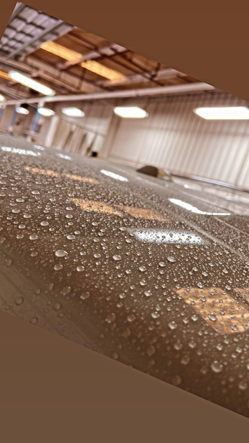 A close up of a pipe with water drops on it.