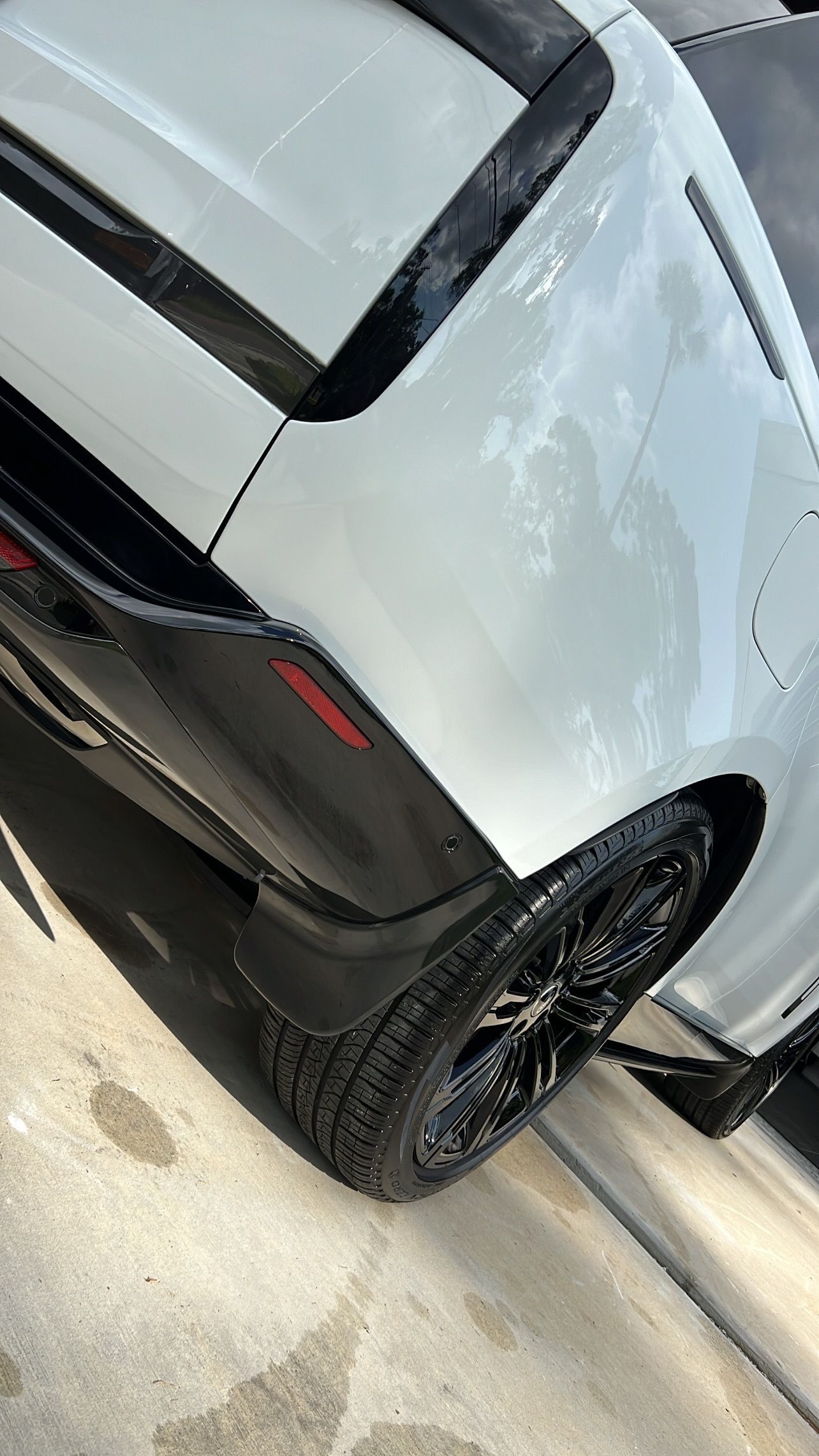 A white car is parked on the side of the road.