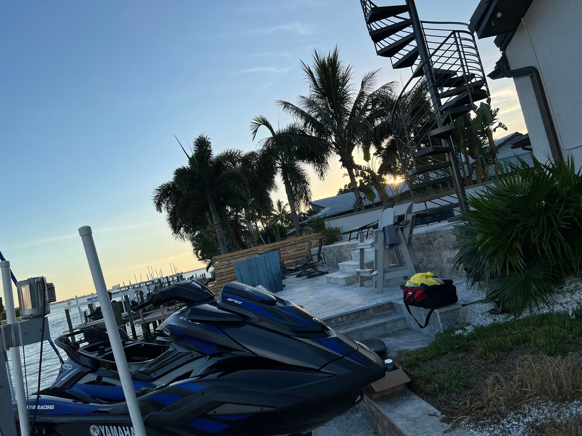 A jet ski is parked on the side of the road in front of a house.