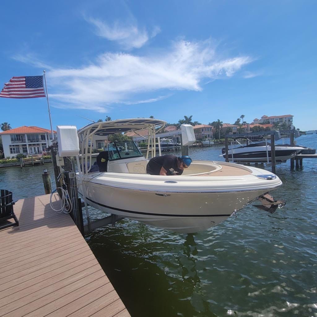 A boat is docked at a dock with an american flag flying in the background