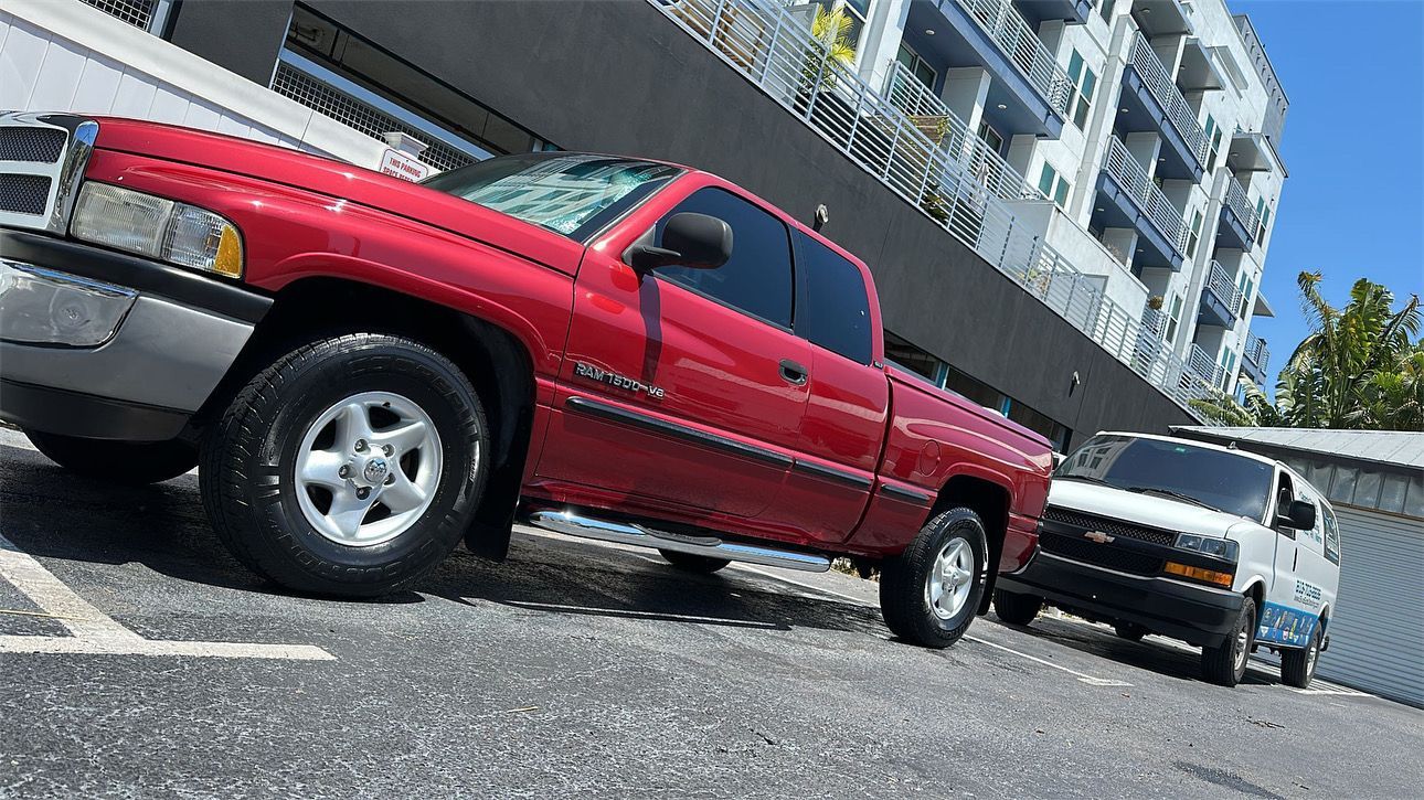 A red dodge ram truck is parked on the side of the road
