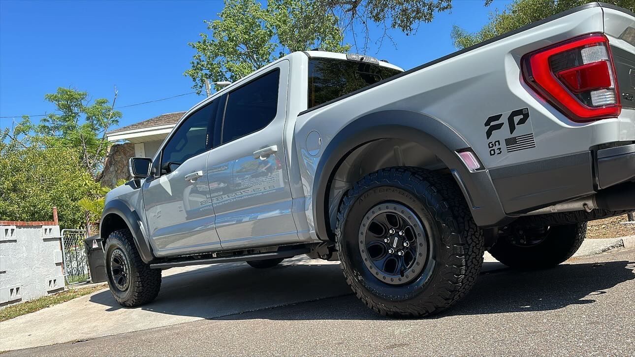 A white truck is parked on the side of the road.