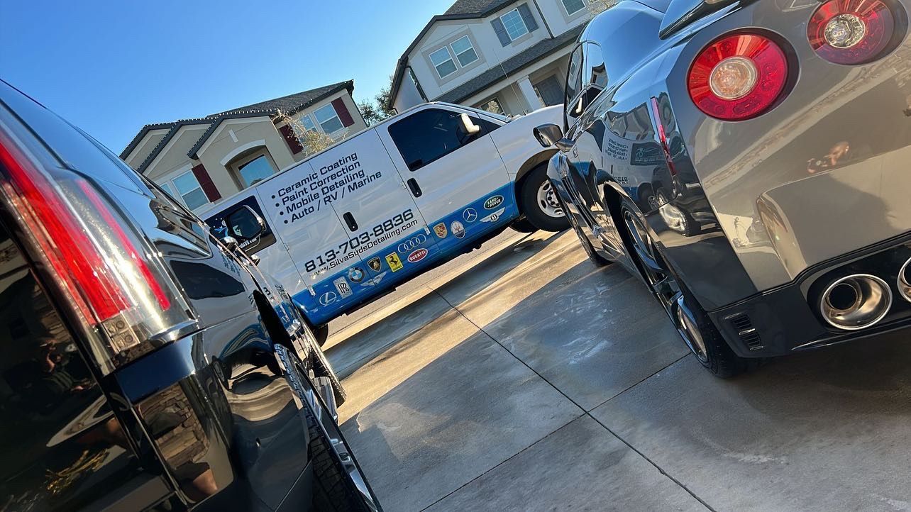 Two cars are parked next to each other in a parking lot.