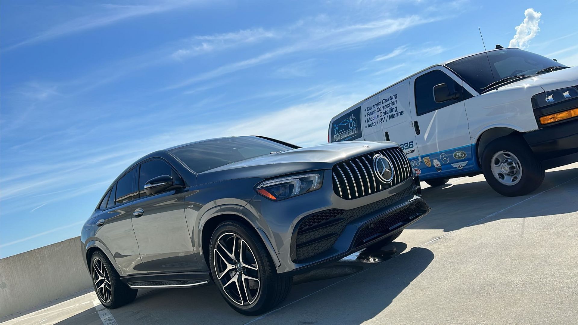 Two cars are parked next to each other in a parking lot.