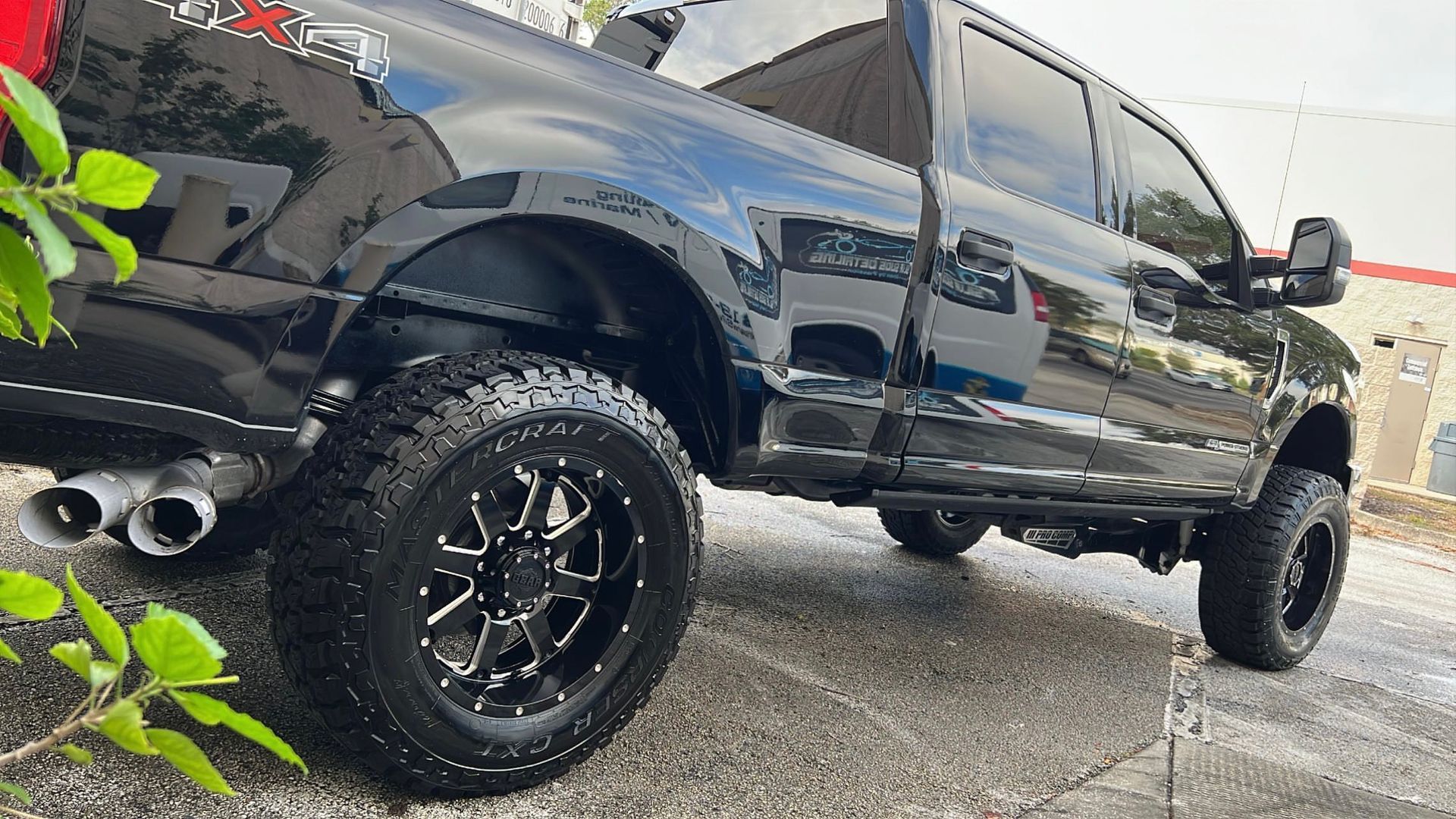 A black truck is parked on the side of the road.