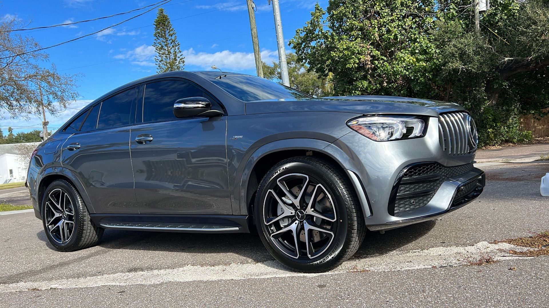 A mercedes benz gle 450 amg is parked on the side of the road.