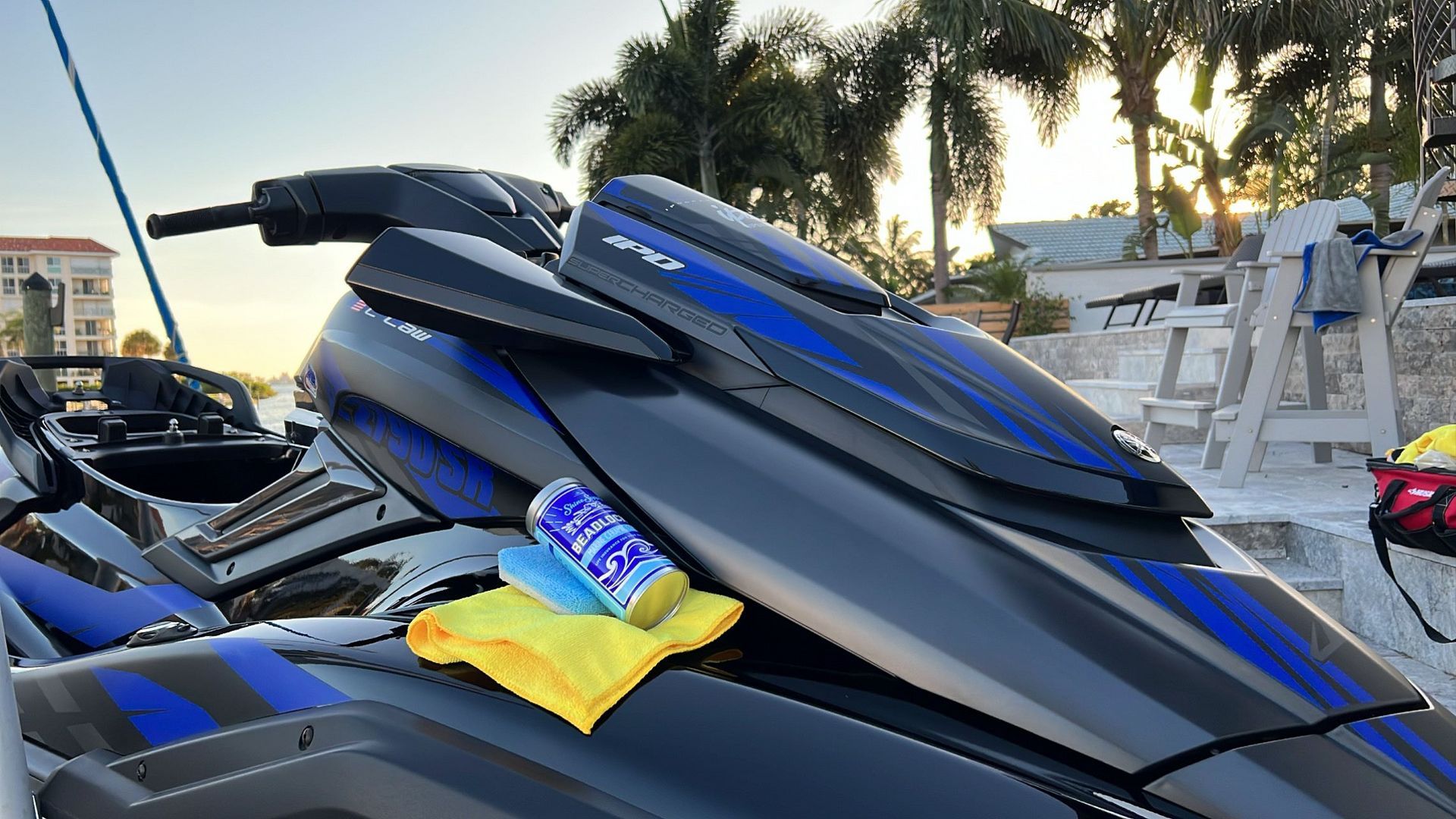 A blue and black jet ski with a yellow towel on the side.