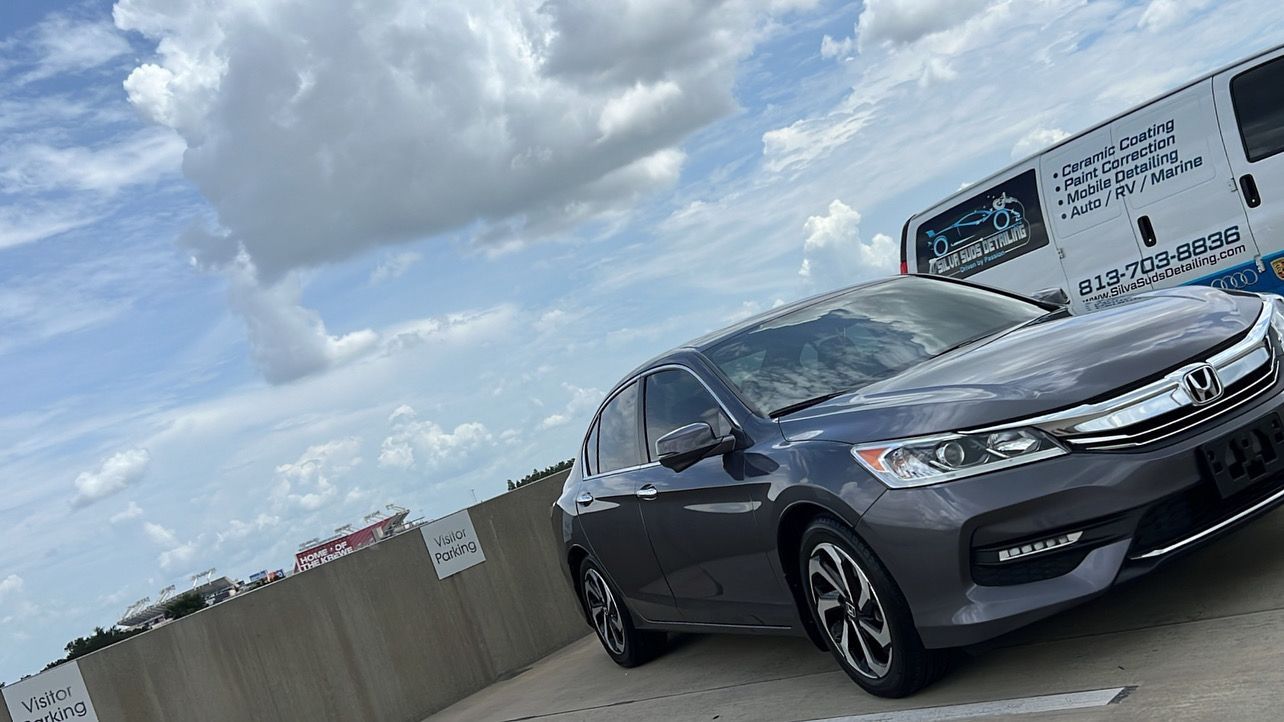 A gray honda accord is parked in a parking lot.