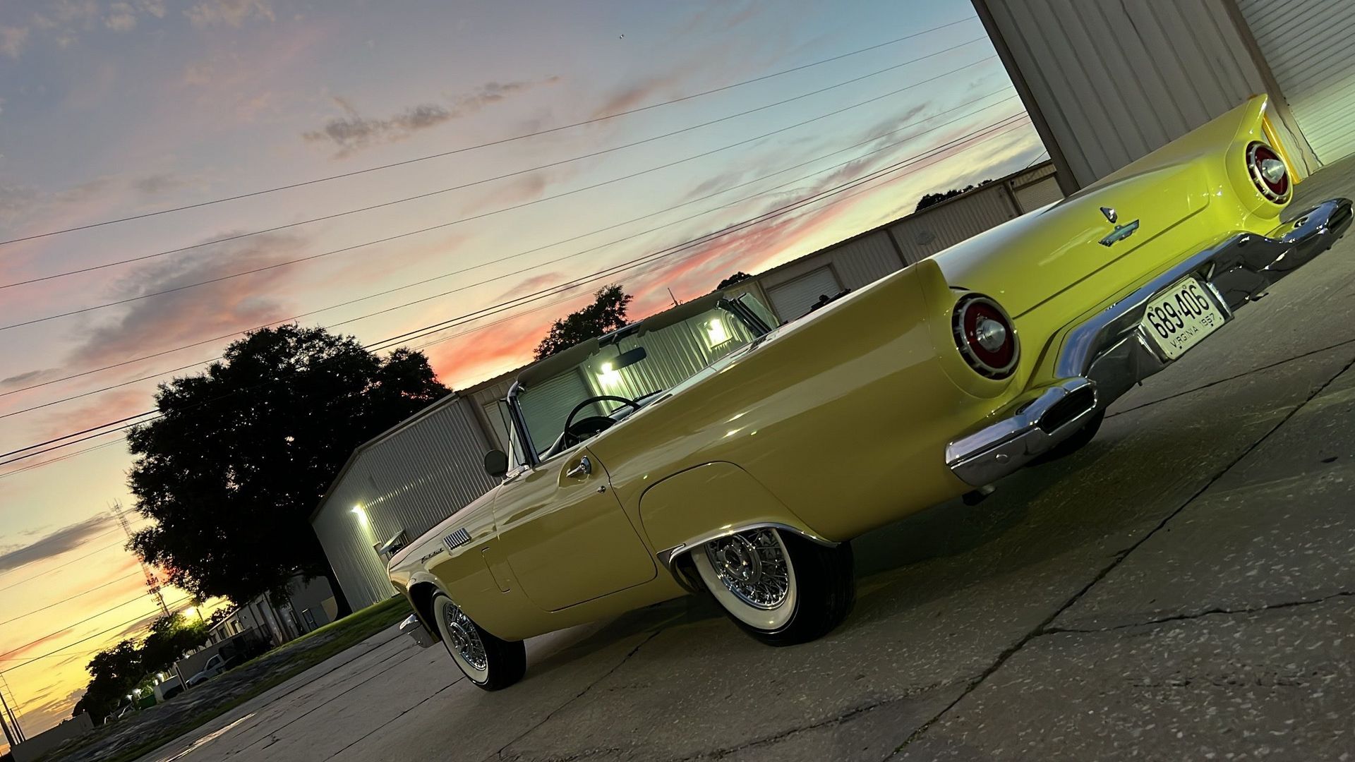 A yellow car is parked on the side of the road