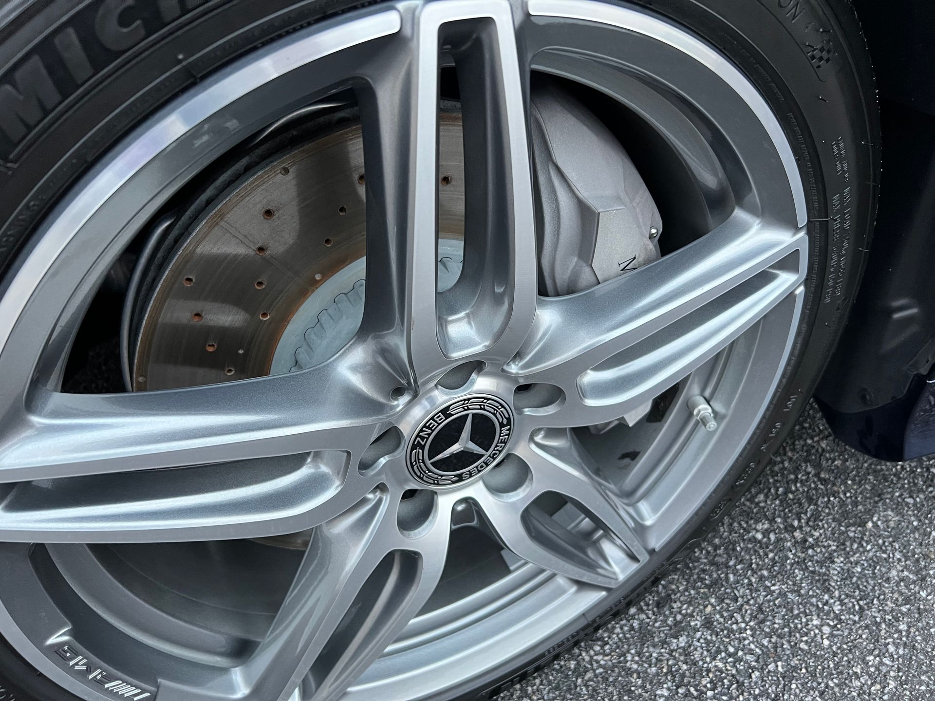 A close up of a car wheel with a mercedes logo on it