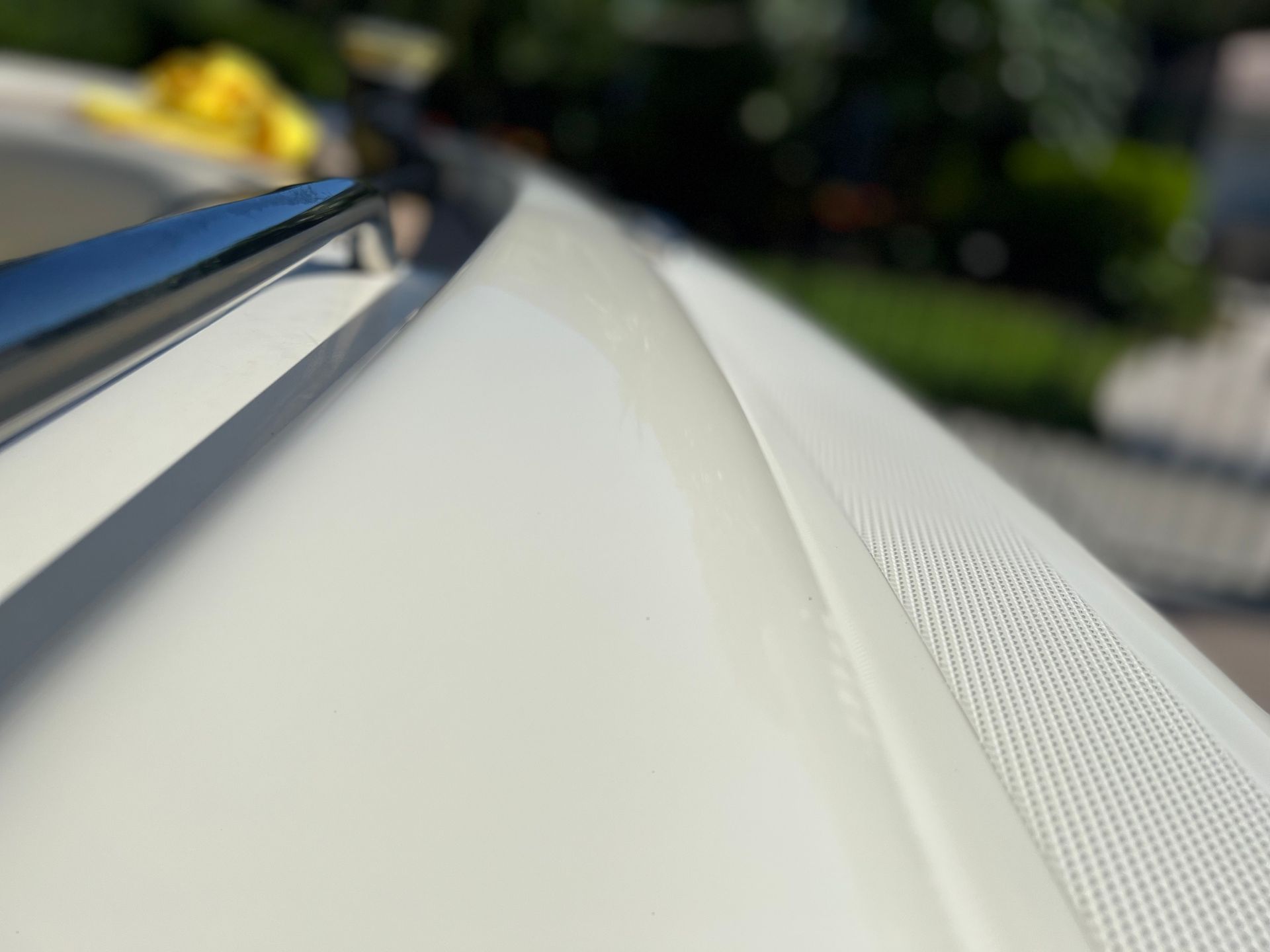 A close up of the hood of a white car.