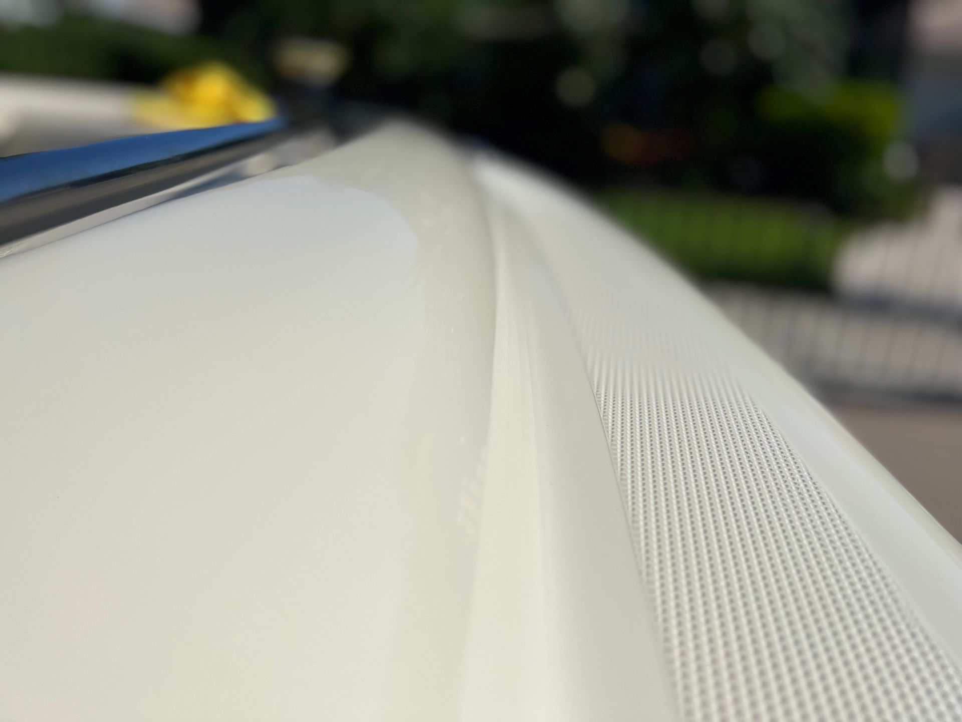 A close up of a white roof of a car.