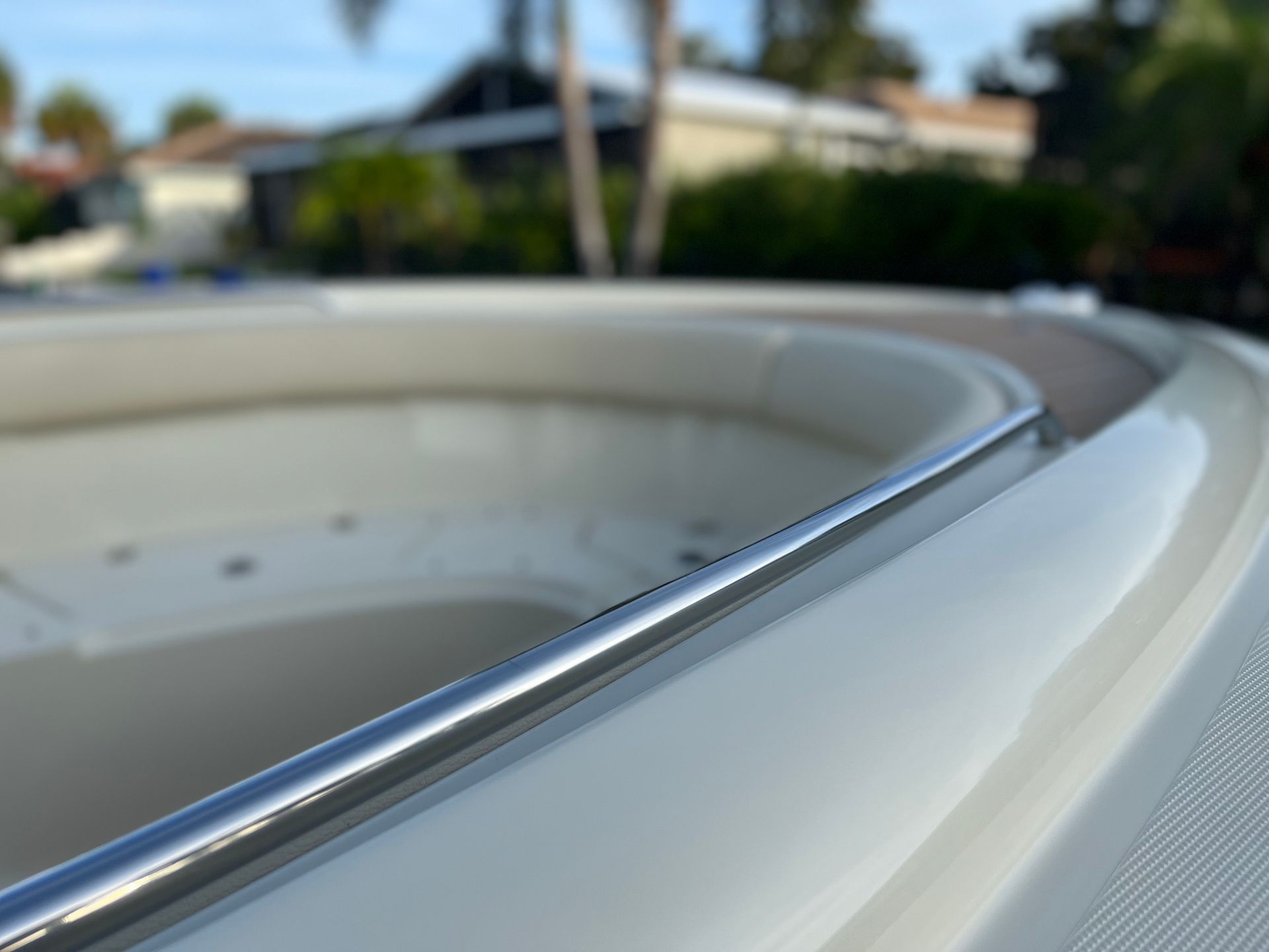 A close up of a boat 's bow with a stainless steel railing.