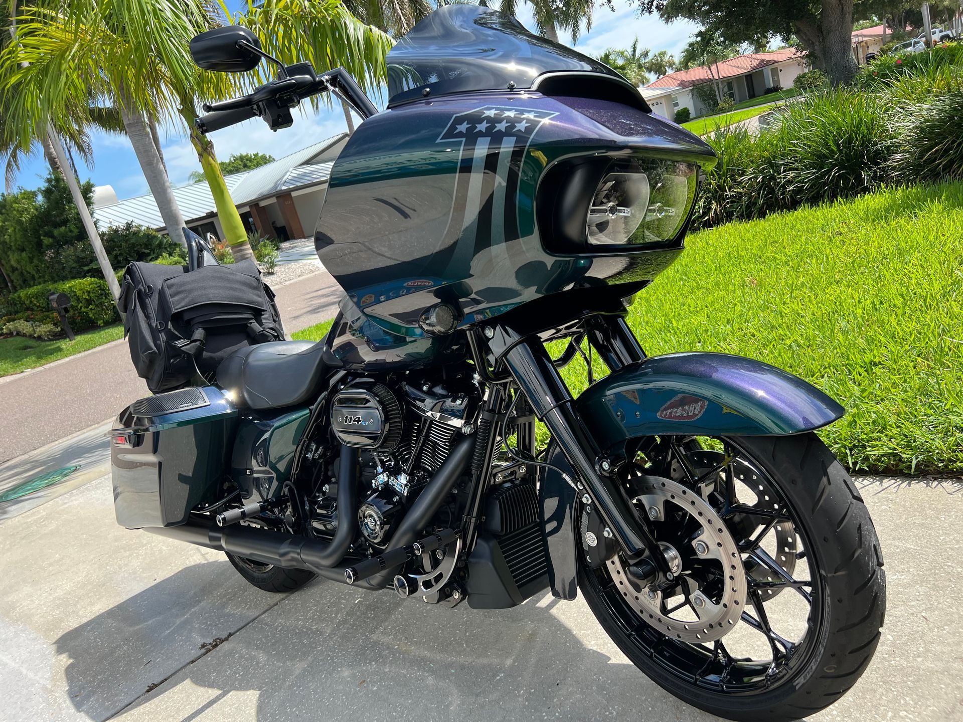 A harley davidson road glide is parked on the side of the road.