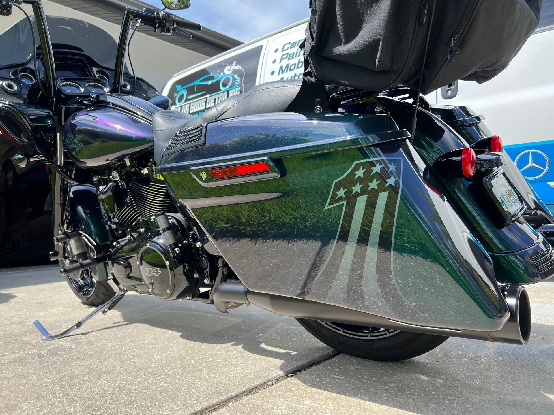 A harley davidson motorcycle is parked on the side of the road.