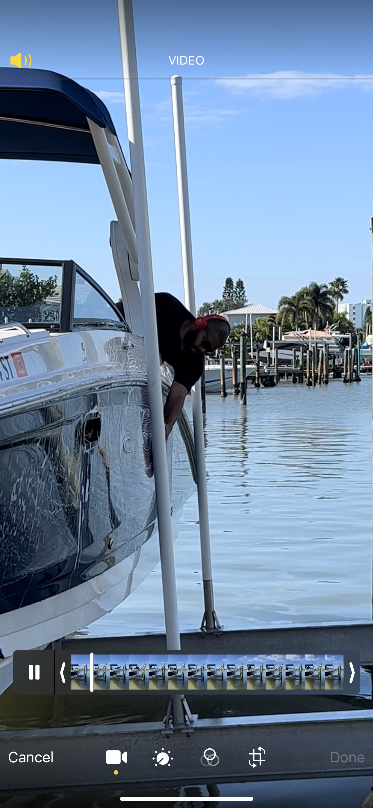 A man is standing next to a boat in the water.