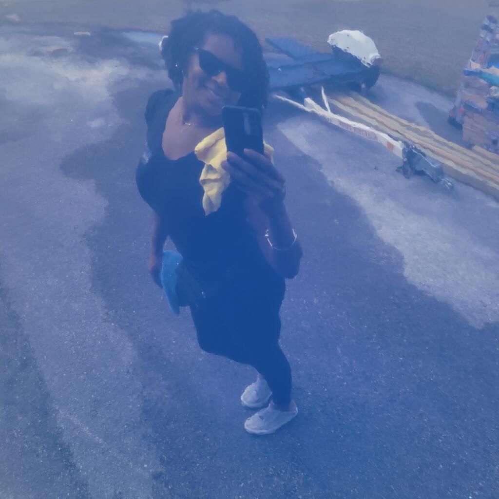 A woman taking a picture of herself with her phone