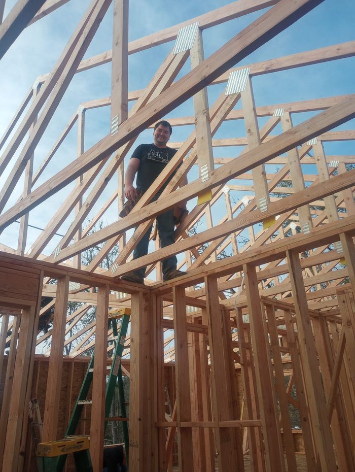 Man Standing On Top Of Wooden Frames — Roseburg, OR — K & R Construction and Framing, Inc.