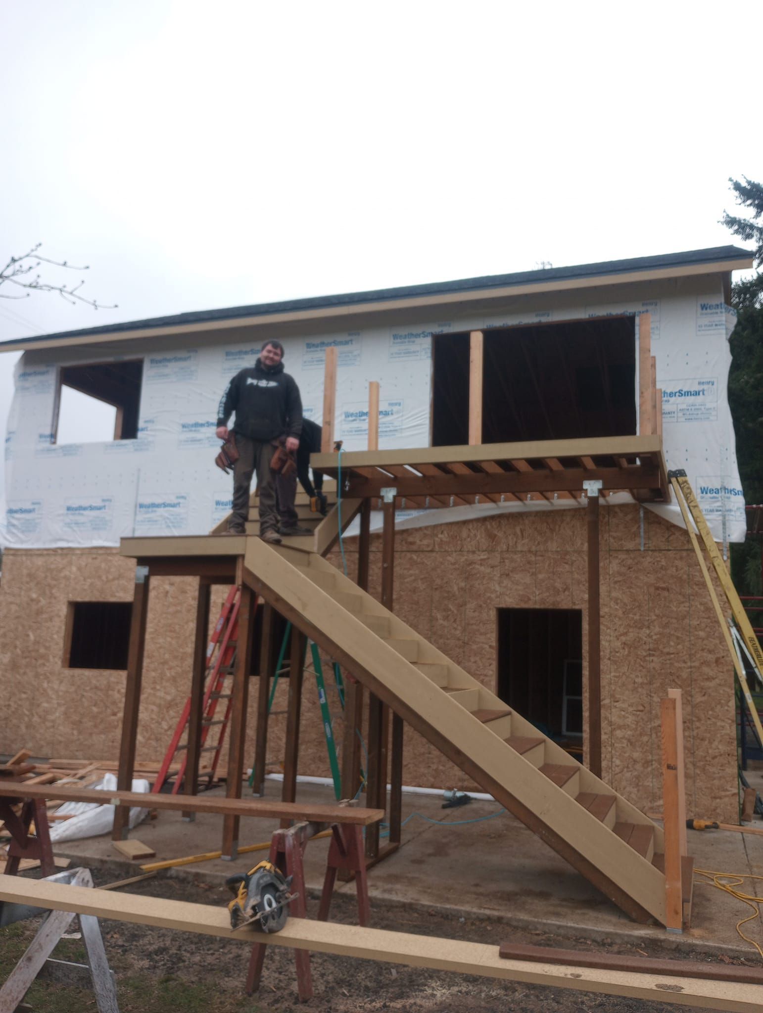 Man On Construction Wooden Staircase — Roseburg, OR — K & R Construction and Framing, Inc.