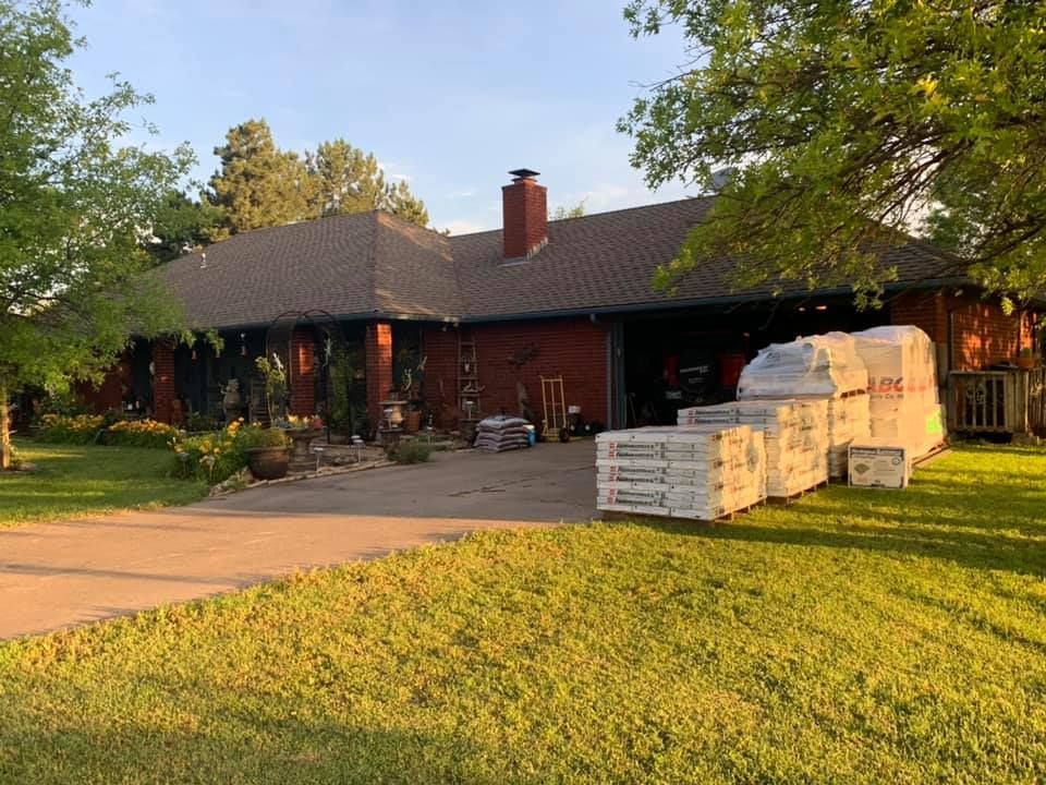 A large brick house with a lot of boxes in front of it.