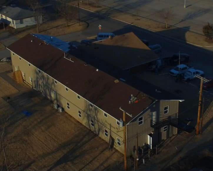 An aerial view of a building with a red roof