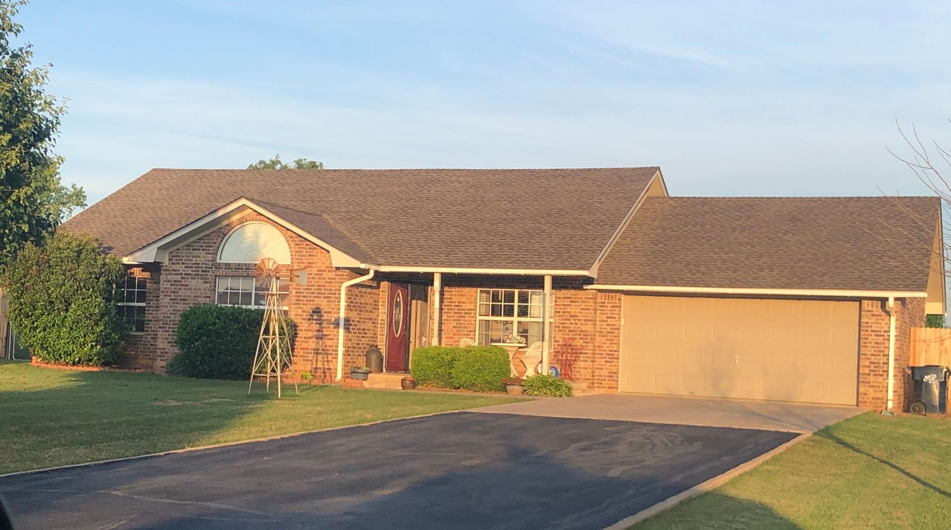 A large brick house with a garage and a driveway.